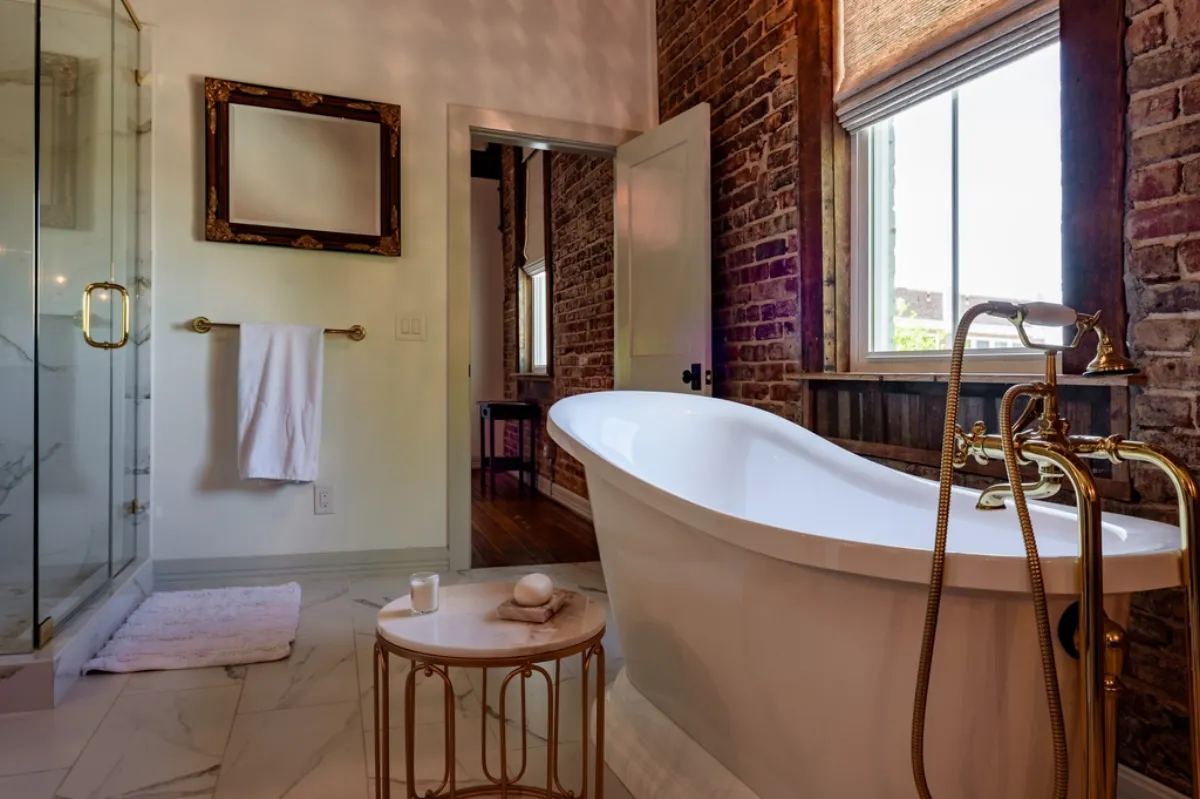 Characterful bathroom with an exposed-brick wall and a freestanding slipper tub