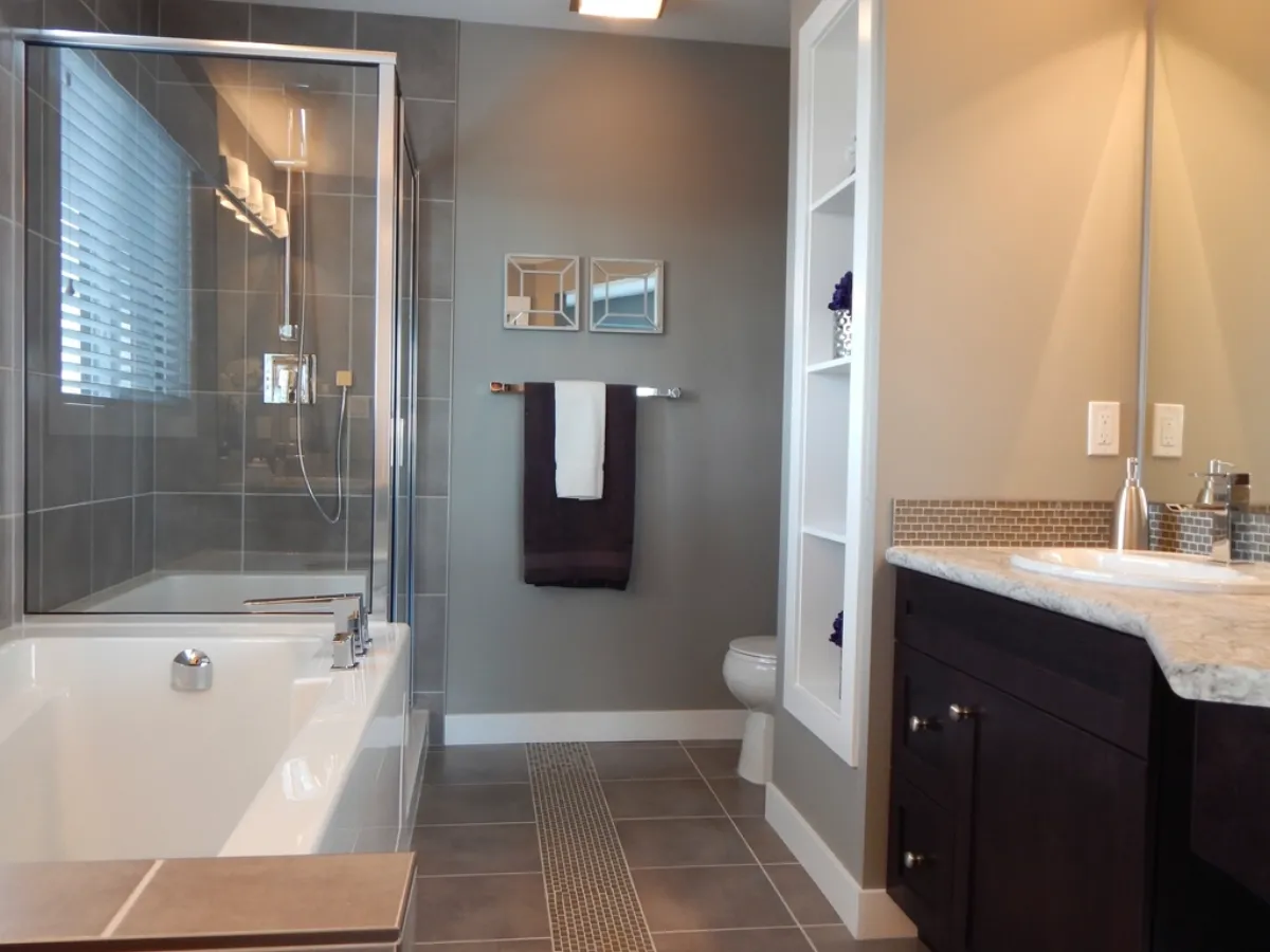 Tiled walk-in shower and vanity in a remodeled bathroom