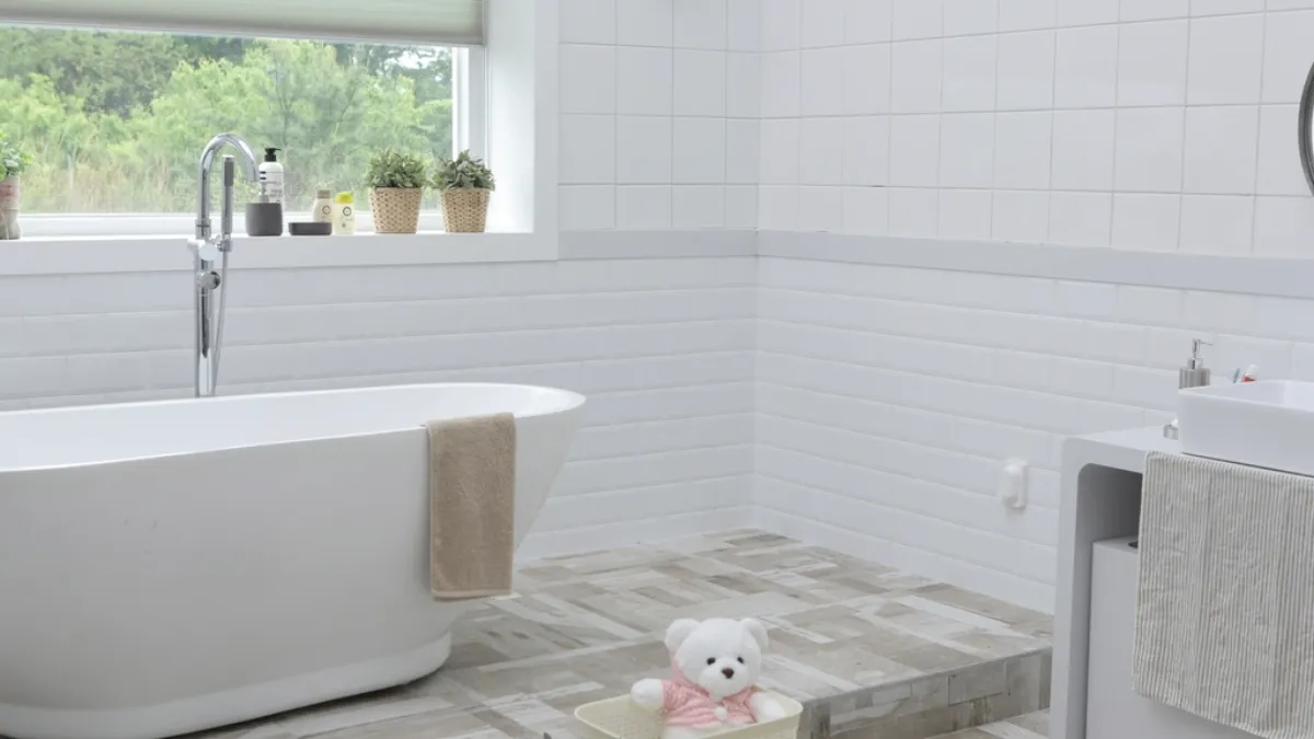 Bright white bathroom with a freestanding tub and a window