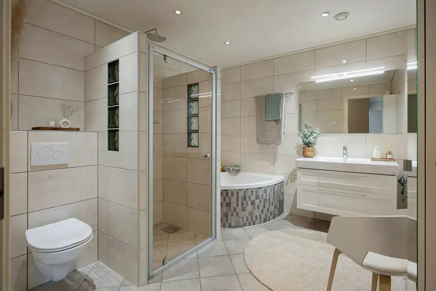 Clean remodeled bathroom with a glass-enclosed shower beside a tub